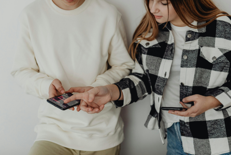 Two teens scrolling on social media